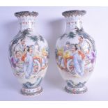 A PAIR OF CHINESE REPUBLICAN FAMILLE ROSE PORCELAIN VASES painted with scholars and unusually a