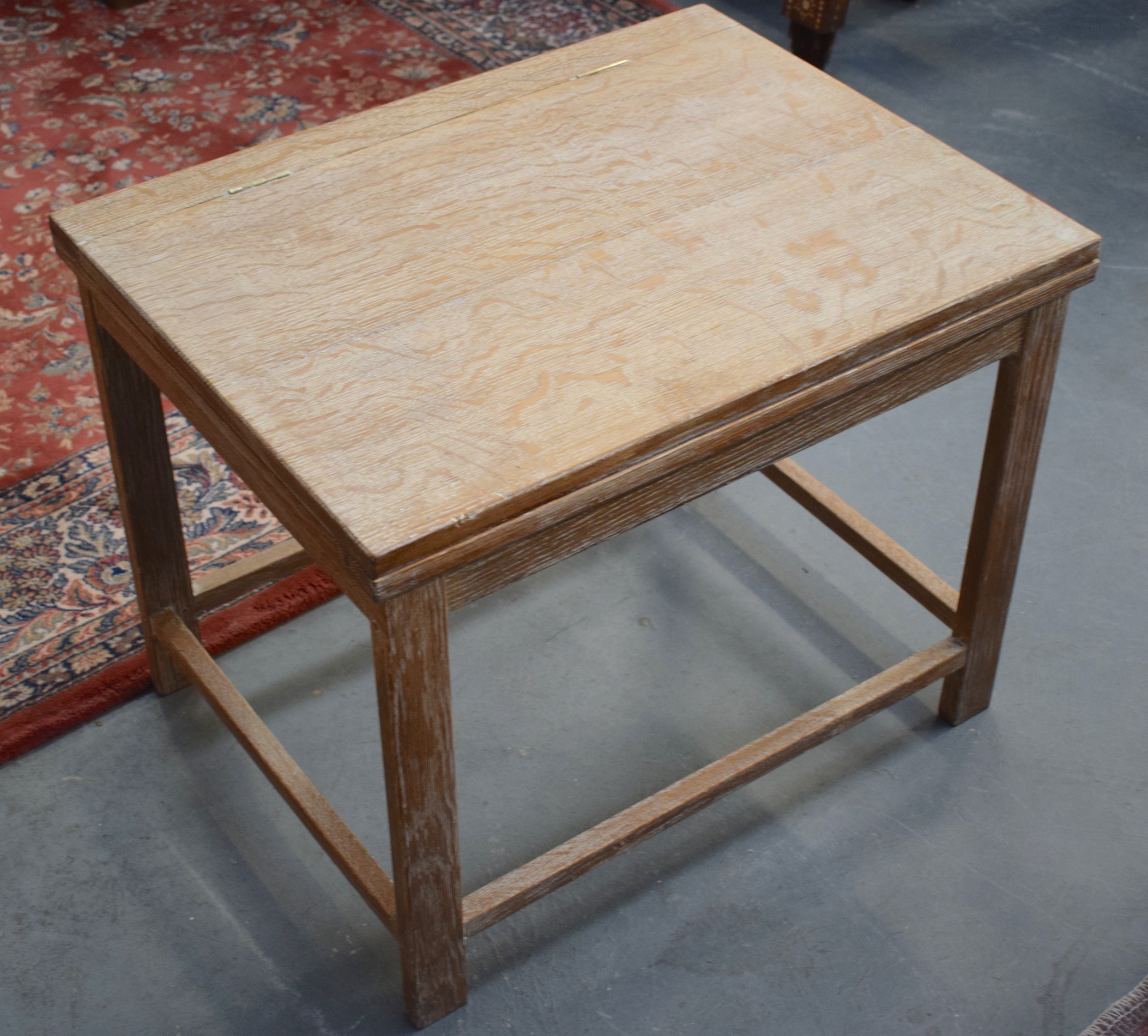 A FOLDING WOODEN DESK/TABLE, in the manner of Heals. 50 cm x 63 cm.