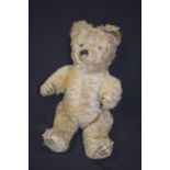 A RARE VINTAGE TOY BEAR, with swivelling head, 51 cm long