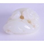 A CHINESE QING DYNASTY CARVED WHITE JADE GROUP depicting two opposing buddhistic beasts. 5 cm wide.