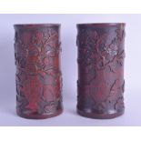 A PAIR OF CHINESE QING DYNASTY CARVED BAMBOO BRUSH POTS Bitong, decorated with urns and flowers.