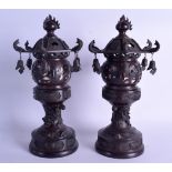 A PAIR OF 19TH CENTURY JAPANESE MEIJI PERIOD TRIPLE SECTION BRONZE LANTERNS AND COVERS overlaid with