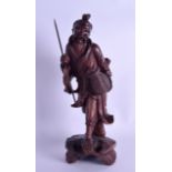 AN EARLY 20TH CENTURY CHINESE CARVED HARDWOOD FIGURE OF A FISHERMAN modelled upon an open work base.