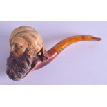 A VICTORIAN CARVED MEERSCHAUM PIPE in the form of a Middle Eastern male, with amber mouth piece.