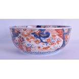 A 19TH CENTURY JAPANESE MEIJI PERIOD IMARI BOWL painted with iron red foliage and blue landscapes.