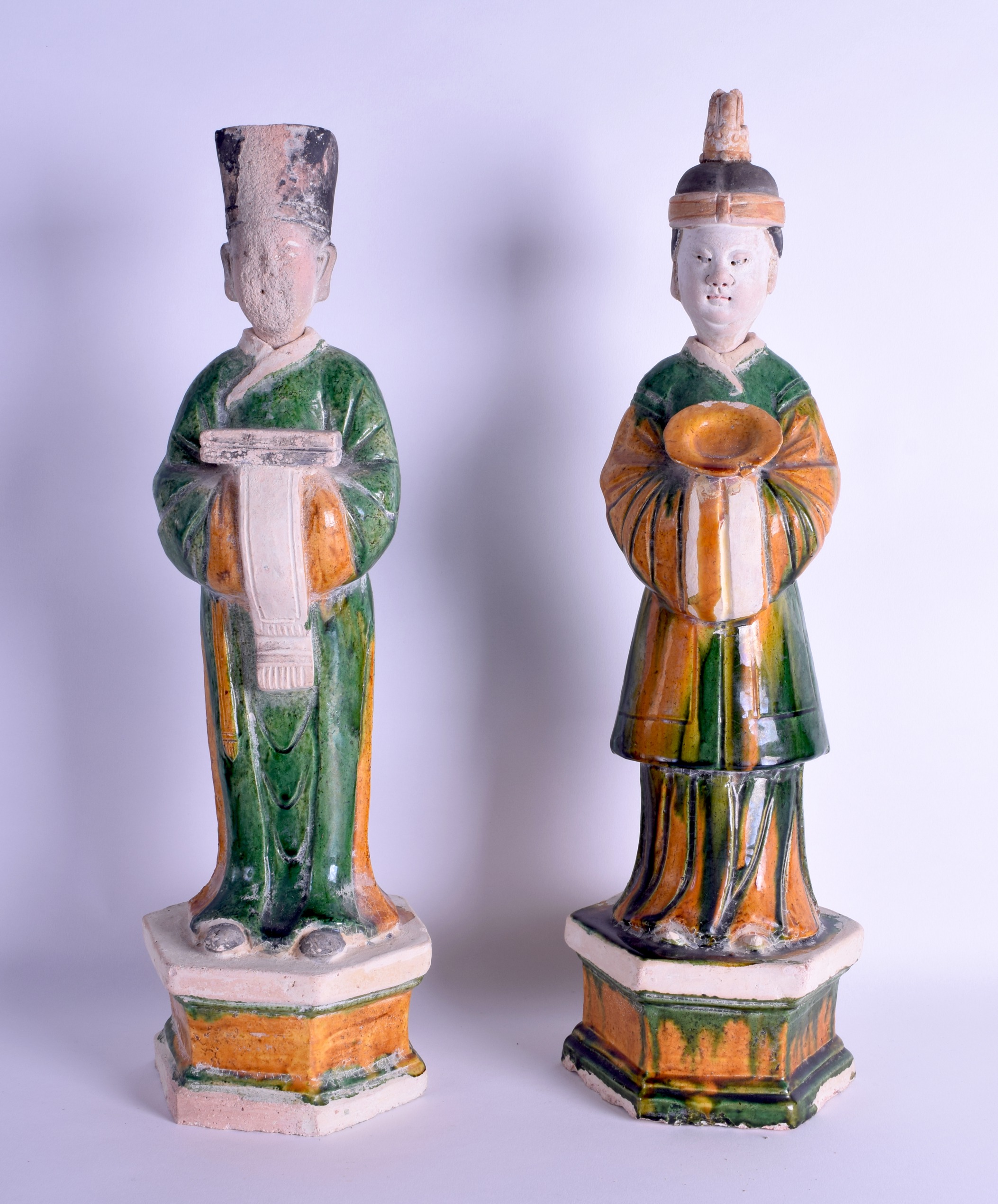 A GOOD PAIR OF CHINESE MING DYNASTY SANCAI GLAZED ATTENDANTS the male wearing flowing robes, the