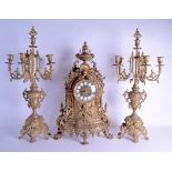 AN EARLY 20TH CENTURY EUROPEAN GILT METAL CLOCK GARNITURE decorated with mask heads and foliage.
