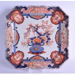 A LARGE 19TH CENTURY JAPANESE MEIJI PERIOD IMARI SQUARE FORM PORCELAIN DISH painted with urns and