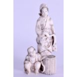 A 19TH CENTURY JAPANESE MEIJI PERIOD CARVED IVORY OKIMONO modelled as a standing female beside a