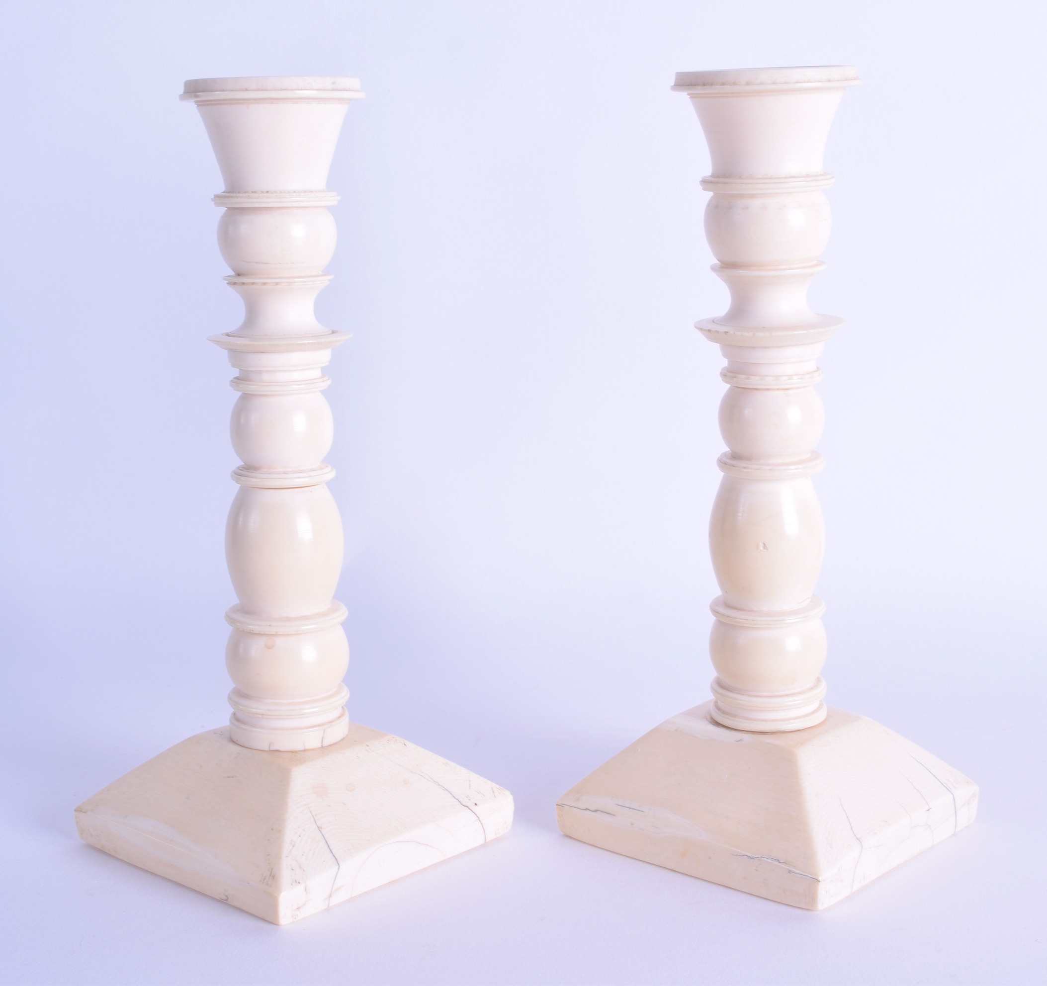 A GOOD PAIR OF MID 19TH CENTURY EUROPEAN CARVED IVORY CANDLESTICKS of ribbed form upon a square - Image 2 of 2