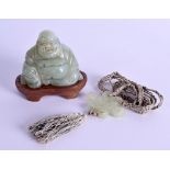 AN EARLY 20TH CENTURY CHINESE CARVED JADE FIGURE OF A BUDDHA together with a hardstone pendant. (2)