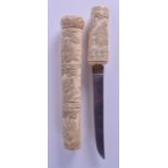 A 19TH JAPANESE MEIJI PERIOD CARVED IVORY TANTO DAGGER unusually carved with monkeys within