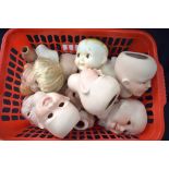 A QUANTITY OF BISQUE PORCELAIN DOLLS HEADS, of similar design. (qty)