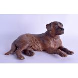 A GOOD EARLY 20TH CENTURY BAVARIAN BLACK FOREST FIGURE OF A DOG well carved and modelled recumbent