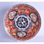 A LARGE 19TH CENTURY JAPANESE MEIJI PERIOD IMARI DISH painted with buddhistic lions, birds and