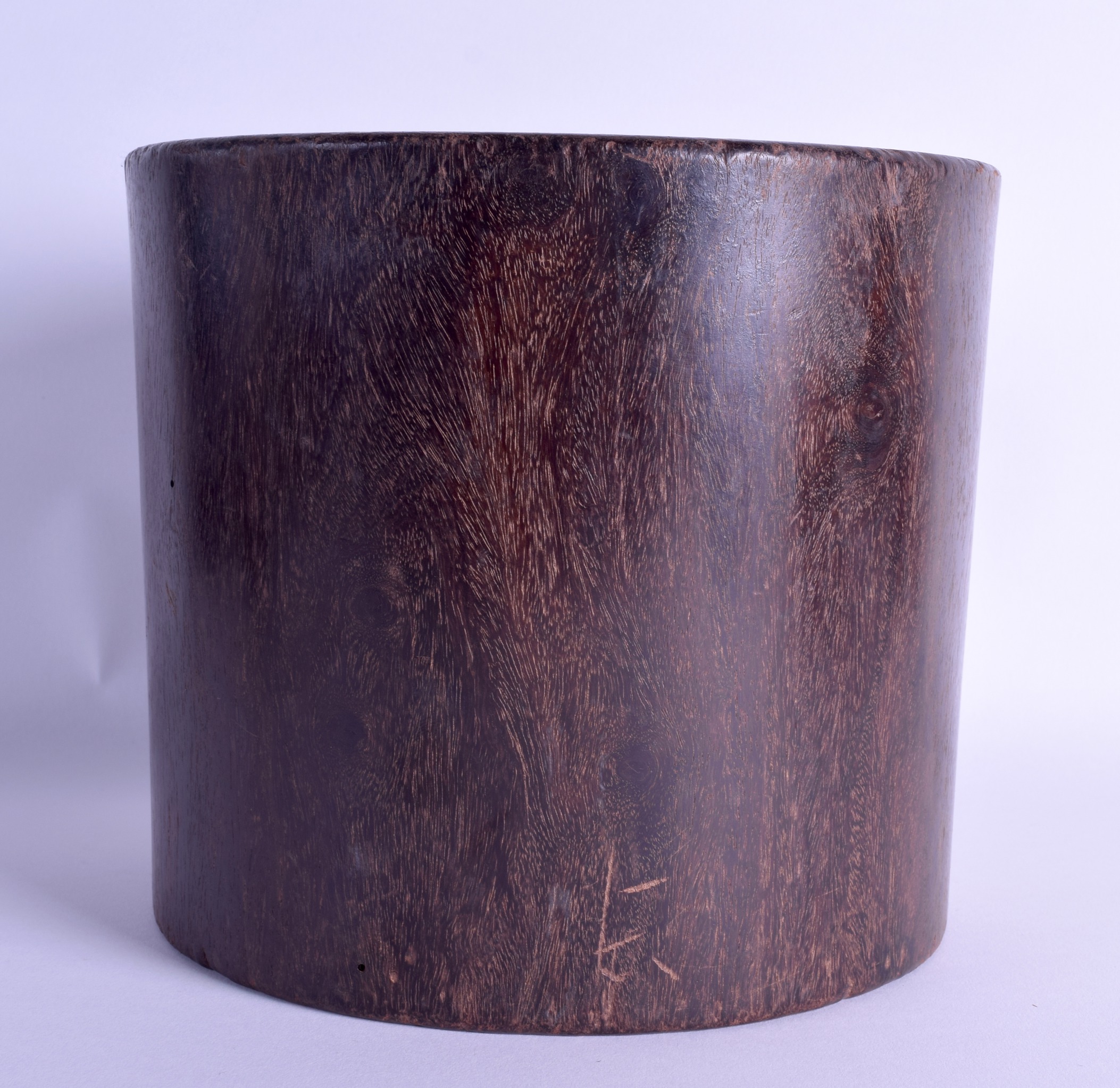 A GOOD CHINESE CARVED HARDWOOD BRUSH POT Bitong, possibly Zitan, of naturalistic form. 1379 grams.