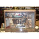 AN EARLY 20TH CENTURY DIORAMA, depicting a group of dolls having a tea party an interior. 25 cm x 35