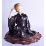 A GOOD 19TH CENTURY JAPANESE MEIJI PERIOD BRONZE AND CARVED IVORY GEISHA modelled holding an