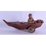 AN EARLY 20TH CENTURY JAPANESE KOBE TOY in the form of a boy upon a rolling boat. 19.5 cm wide.