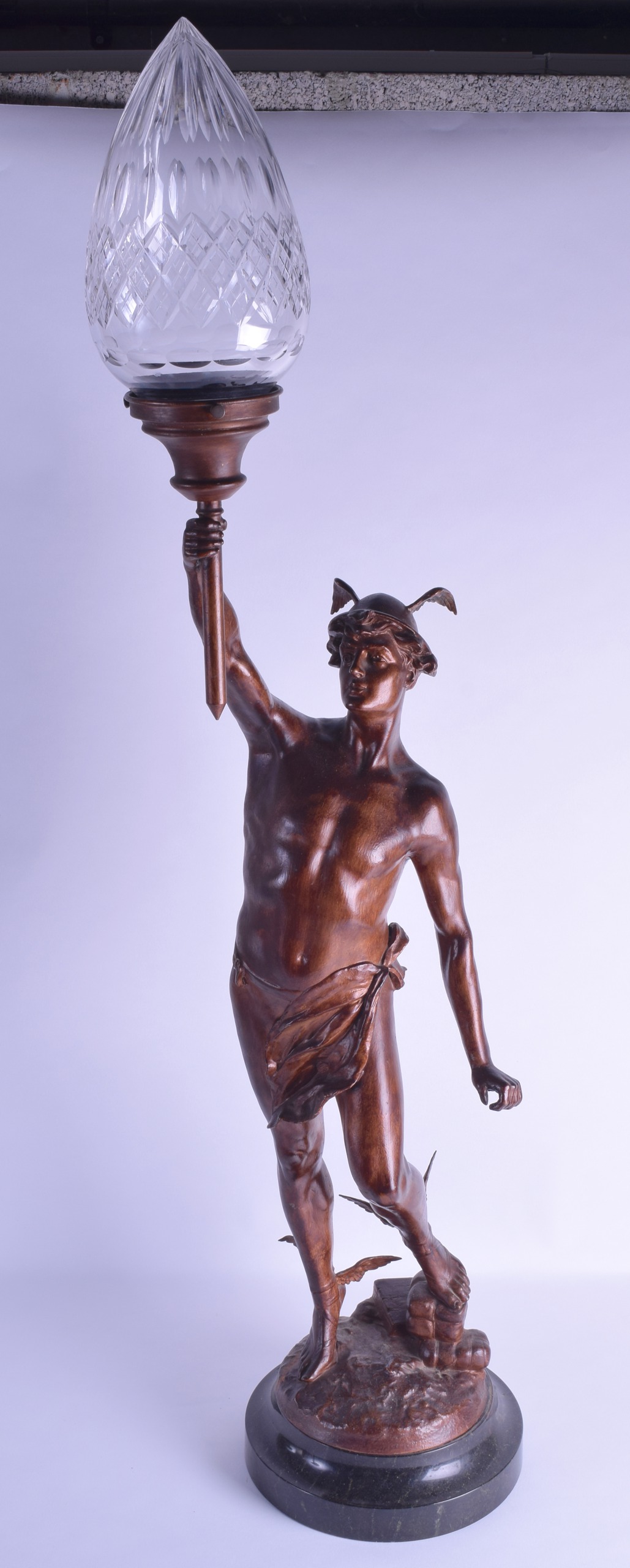 AN ART NOUVEAU COLD PAINTED SPELTER FIGURAL LAMP modelled as a classical male holding aloft a