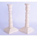 A GOOD PAIR OF MID 19TH CENTURY EUROPEAN CARVED IVORY CANDLESTICKS of ribbed form upon a square
