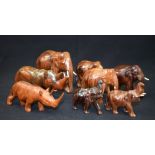 A FROUP OF CARVED WOODEN ELEPHANTS, together with two rhinoceros. Largest 13.5 cm long. (8)