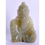 AN EARLY 20TH CENTURY CHINESE CARVED GREEN HARDSTONE FIGURE OF A MALE modelled as a seated