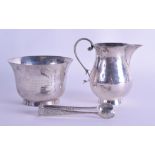 AN ART DECO HAMMERED SILVER SUGAR BASIN AND CREAM JUG with associate similar sugar tongs. Chester