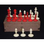 A 19TH CENTURY STAINED BONE CHESS SET, part complete, contained within a box. Largest piece 4.5 cm