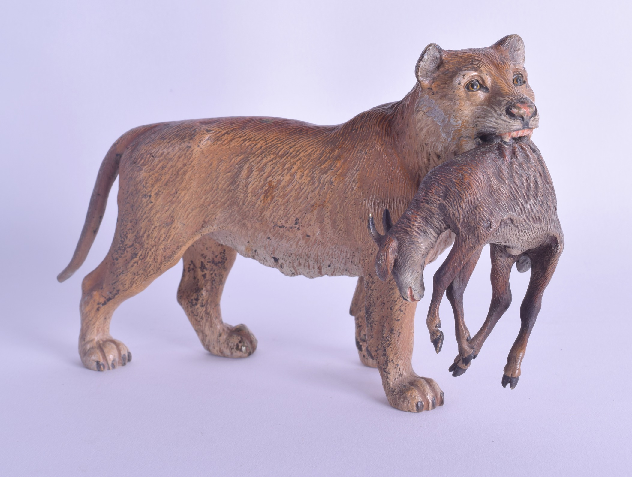 A RARE LATE 19TH CENTURY AUSTRIAN COLD PAINTED BRONZE FIGURE OF A LIONESS modelled holding a kid