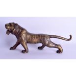 A JAPANESE TAISHO PERIOD BRONZE OKIMONO modelled as a roaming tiger. 34 cm long.