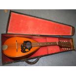 A 20TH CENTURY CASED MANDOLIN.