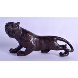 A JAPANESE BRONZE FIGURE OF A ROAMING TIGER 20th Century, modelled in a roaming stance. 30 cm long.