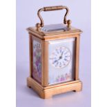 A CONTEMPORARY MINIATURE BRASS CARRIAGE CLOCK with pink porcelain inset panels. 7.5 cm high inc