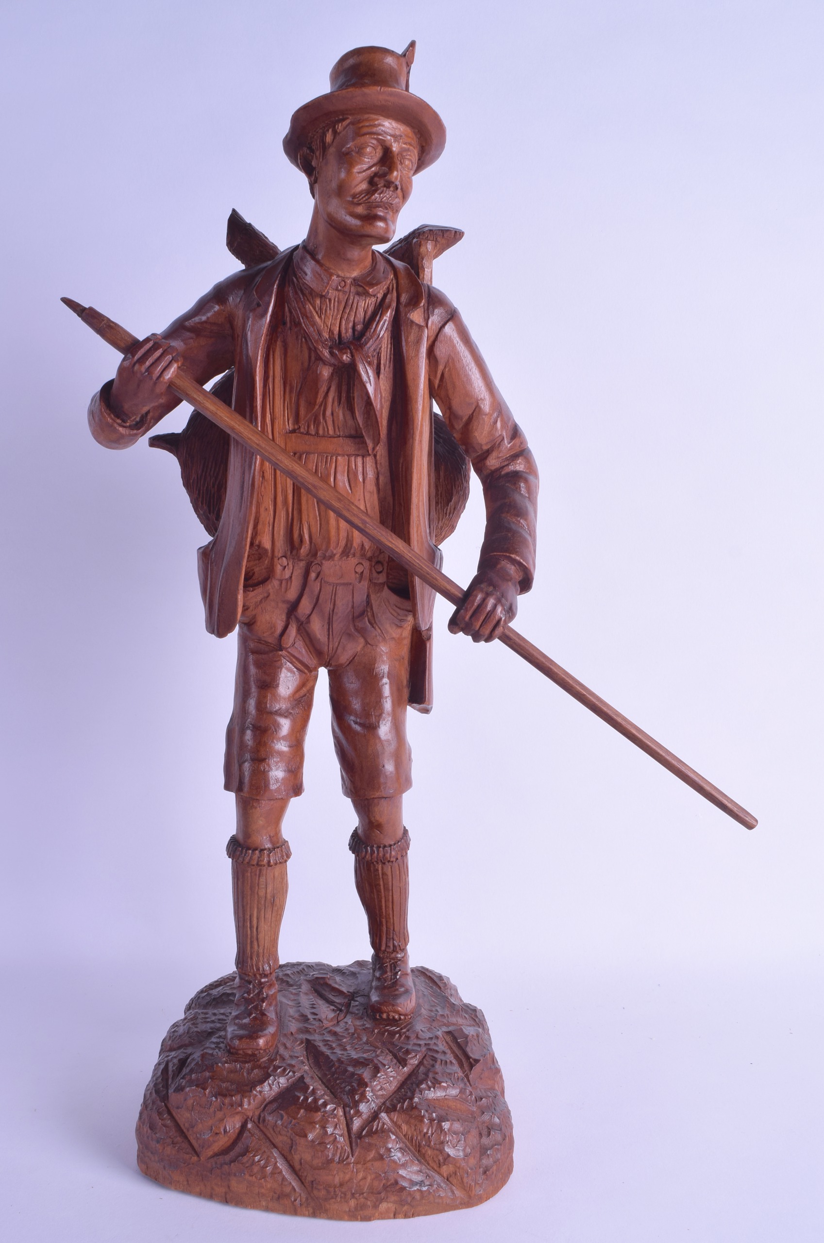 A LARGE EARLY 20TH CENTURY BAVARIAN BLACK FOREST FIGURE OF A HUNTER modelled upon a naturalistic