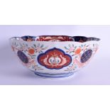 A 19TH CENTURY JAPANESE MEIJI PERIOD IMARI BOWL painted with buddhistic lions and landscapes. 21