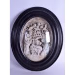 AN 18TH/19TH CENTURY CONTINENTAL OVAL NATIVITY PLAQUE decorated with figures and saints within a