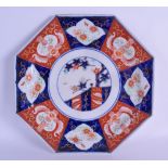 A 19TH CENTURY JAPANESE MEIJI PERIOD IMARI OCTAGONAL DISH painted with panels of flowers and iron