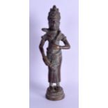 A 19TH CENTURY INDIAN BRONZE FIGURE OF A STANDING BUDDHA modelled holding her chest. 28 cm high.