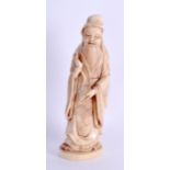 A LATE 19TH CENTURY JAPANESE MEIJI PERIOD CARVED IVORY OKIMONO modelled as a male scholar holding