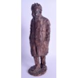 AN UNUSUAL EUROPEAN TERRACOTTA FIGURE OF A ROAMING TRAMP modelled upon a textured base. 28 cm high.