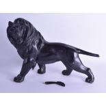 A 19TH CENTURY JAPANESE MEIJI PERIOD BRONZED OKIMONO modelled as a roaming lion. 42 cm long.