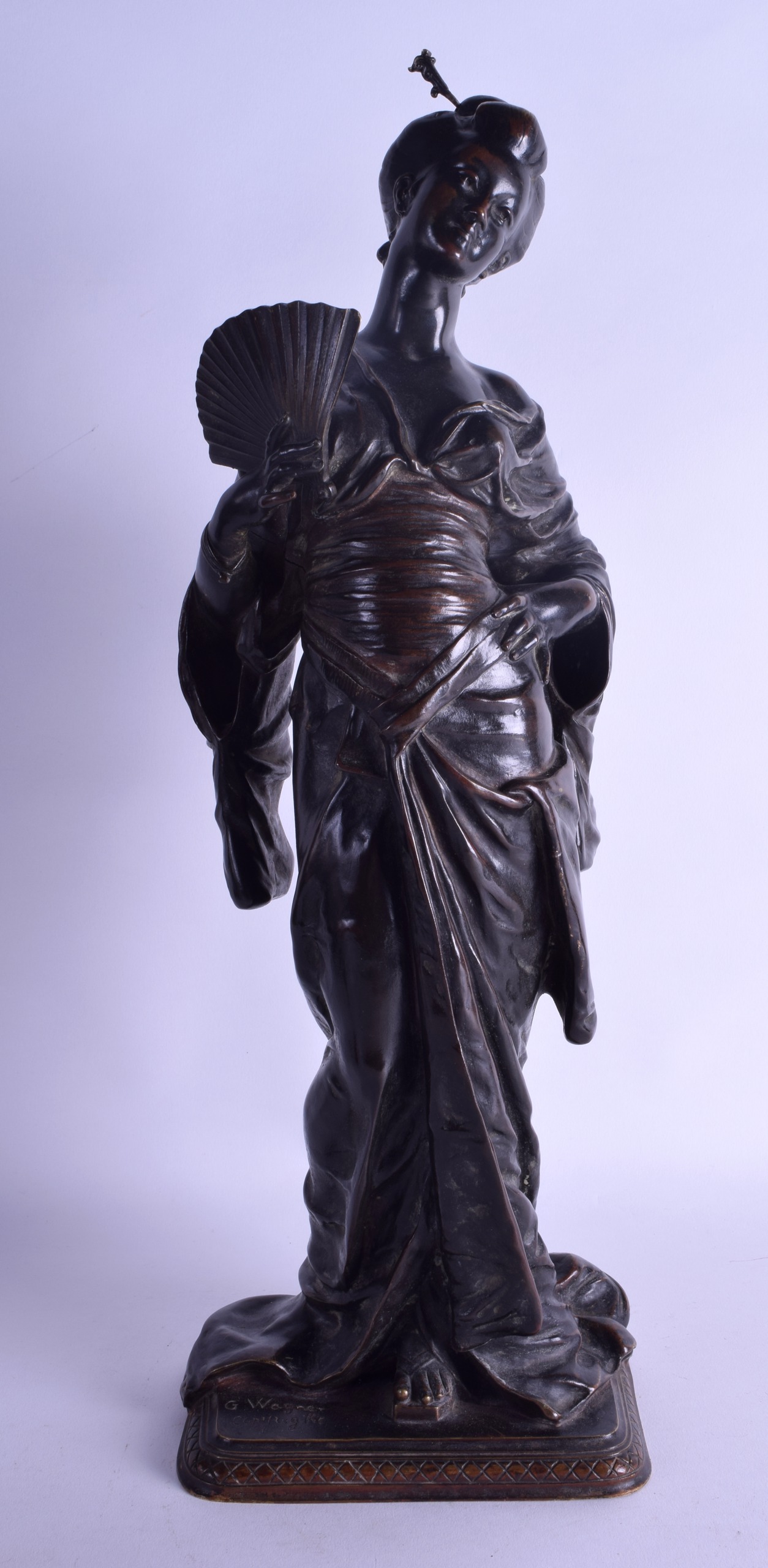 A GOOD 19TH CENTURY FRENCH BRONZE FIGURE OF A JAPANESE GEISHA by G Wagner, modelled holding a fan.