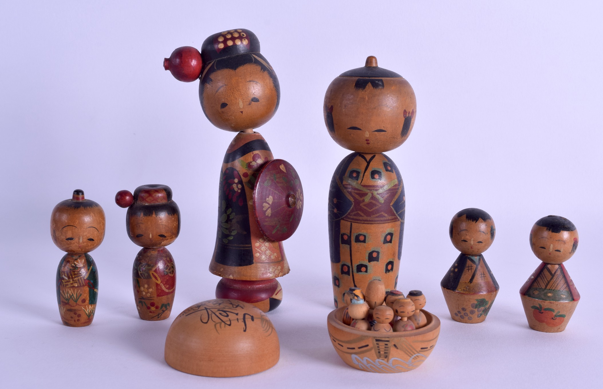 AN EARLY 20TH CENTURY JAPANESE MEIJI PERIOD PAINTED WOOD KOBE FAMILY in various forms and sizes.