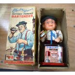 A VINTAGE BOXED TIN PLATE BATTERY OPERATED CHARLEY WEAVER BARTENDER TOY.