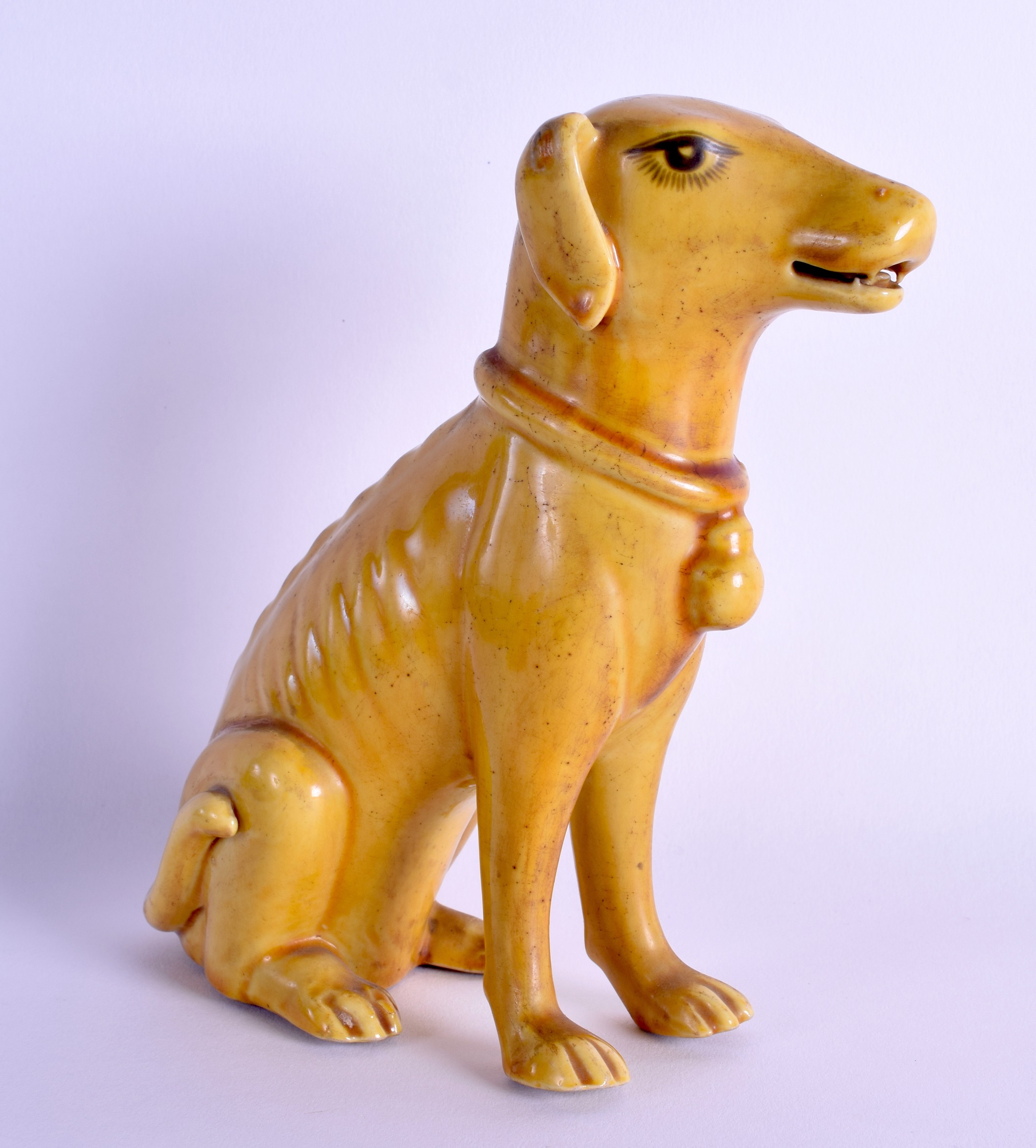 A 19TH CENTURY CHINESE YELLOW GLAZED FIGURE OF A HOUND Kangxi style, modelled standing on its