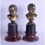 A PAIR OF LATE 19TH CENTURY FRENCH BRONZE BUSTS OF TWO YOUNG BOYS modelled upon veined marble bases.