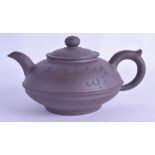 A CHINESE YIXING POTTERY TEAPOT AND COVER incised with calligraphy. 16 cm wide.