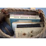 A BASKET CONTAINING VARIOUS FISHING BOOKS.