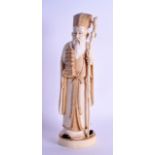 A LOVELY 19TH CENTURY JAPANESE MEIJI PERIOD CARVED IVORY OKIMONO modelled as a standing scholar